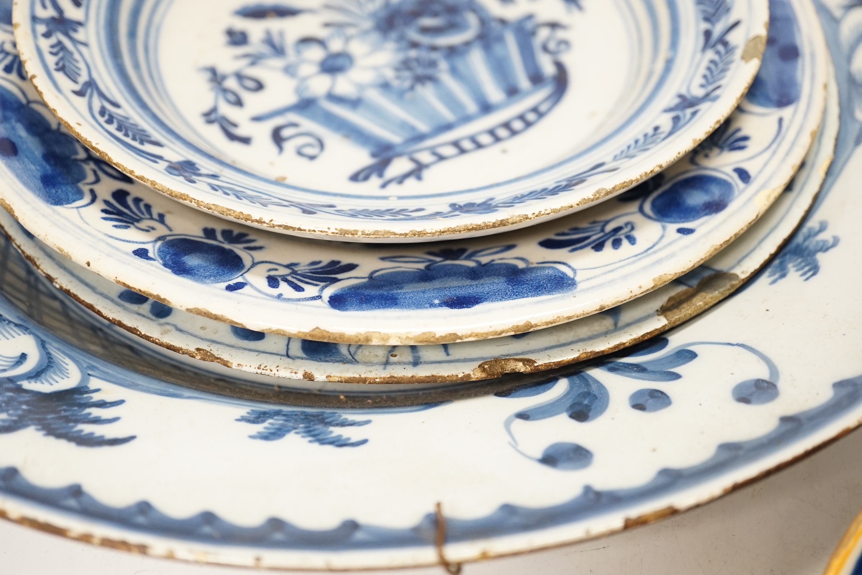 Five 18th century assorted Delft dishes and a plate, largest 35cm diameter